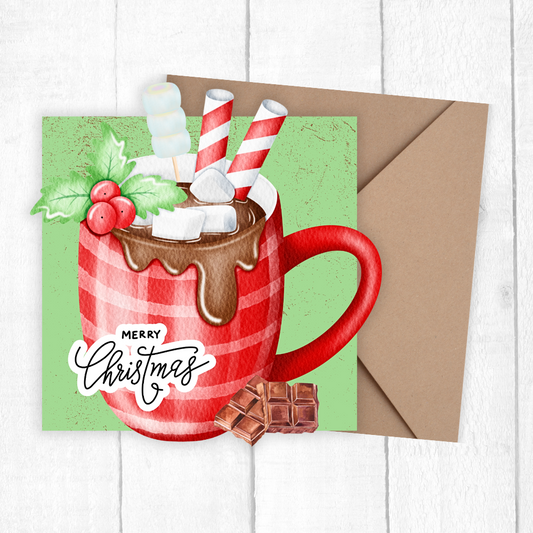 Christmas-themed greeting card with a red mug of hot chocolate, marshmallows, and a candy cane on a green background.
