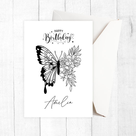 Black and white birthday card with butterfly and floral design on a white background. Amelia Personalised Happy Birthday Card