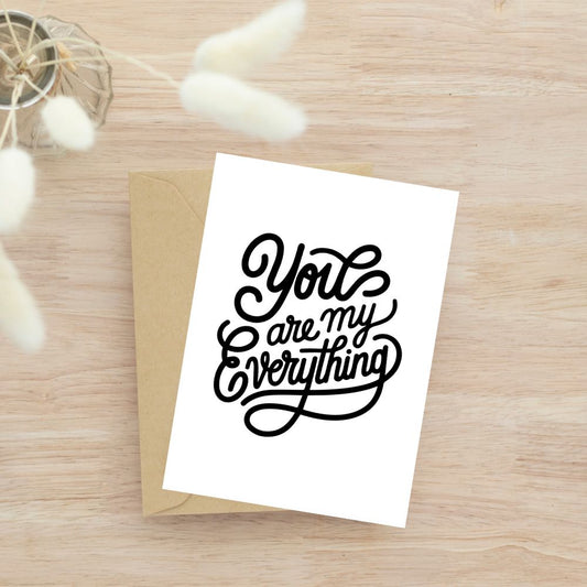 Greeting card with 'You are my Everything' text on a wooden surface. Anniversary or Valentine's Card