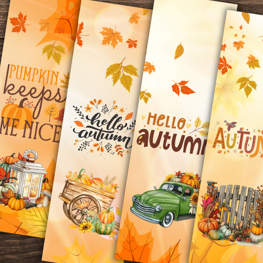 Four autumn-themed bookmarks with pumpkins, leaves, and vintage car designs on a wooden surface.