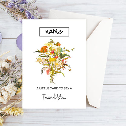 Greeting card with floral design and envelope on a wooden surface. Autumn Flowers Thank You Personalised Card