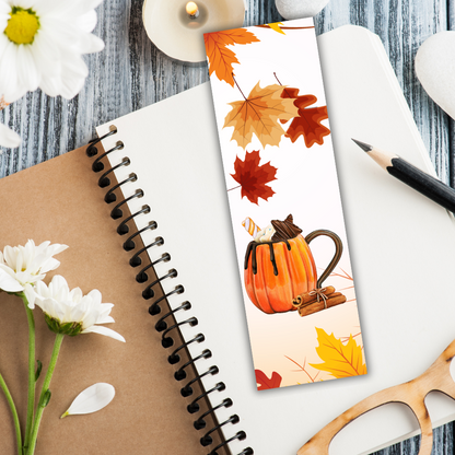 Bookmark with pumpkin and leaves design on a notebook with flowers and glasses.