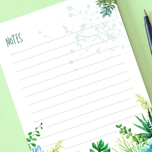Notebook page with 'NOTES' heading and green plant designs on a green background. BOTANICAL DESIGN A6 NOTEPAD