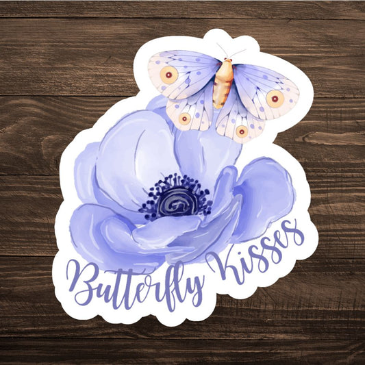 Sticker with a butterfly and flower design on a wooden surface. BUTTERFLY KISSES STICKER