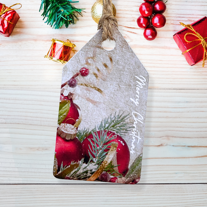 Decorative Christmas tag with red ornaments and pine branches on a wooden surface.Bauble Christmas Gift Tag Set