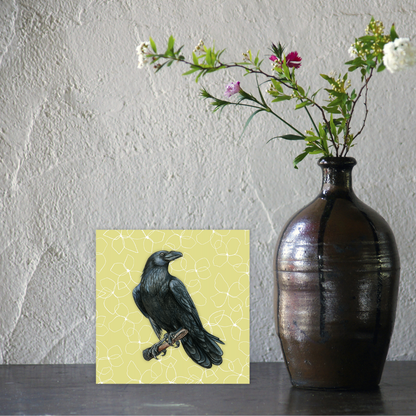 Vase with flowers next to a painting of a raven on a textured wall background birthday card