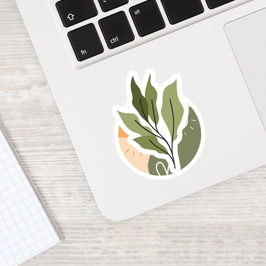 Laptop with a leaf-themed sticker on a light wooden surface.  Boho Aesthetics plant Sticker 