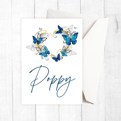 Card with blue butterflies and the name 'Poppy' on a white background. Butterflies Love Personalised Card