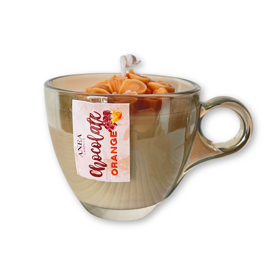 Clear glass mug with a tea bag labeled 'Chocolate Orange' on a white background. CHOCOLATE ORANGE FLOWERS CANDLE