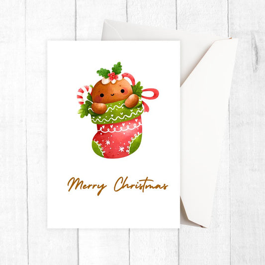 Christmas card with a cute gingerbread man in a stocking and candy canes on a white background.CHRISTMAS SOCK CHRISTMAS CARD