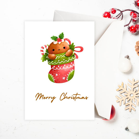 Christmas card with a gingerbread man in a stocking and 'Merry Christmas' text on a white background.CHRISTMAS SOCK CHRISTMAS CARD