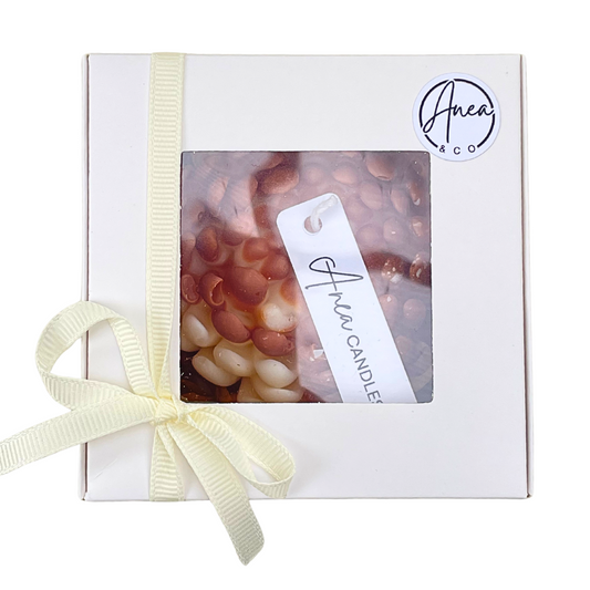 Gift box with a candle and decorative ribbon, featuring the brand 'Anea & Co'.CHRYSANTHEMUM CINNAMON BUN CANDLE GIFT BOX