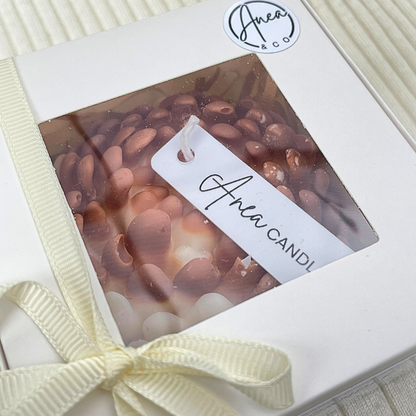 Candle in a box with a visible brand label on a white background. CHRYSANTHEMUM CINNAMON BUN CANDLE GIFT BOX