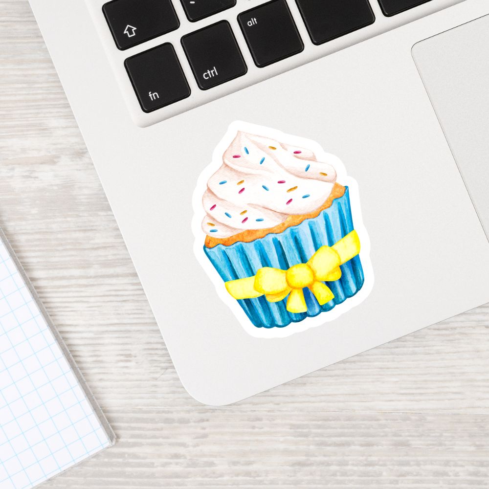 Cupcake sticker with a yellow bow on a laptop keyboard. CUPCAKE STICKER 