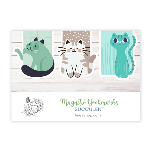 Set of three cat-shaped magnetic bookmarks on a wooden background with 'AneaShop.com' branding. Cats Magnetic Bookmark Set