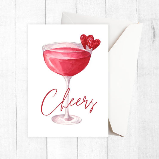 Red cocktail in a glass with 'Cheers' text on a white background. Cheers wine Hearts Birthday Card 