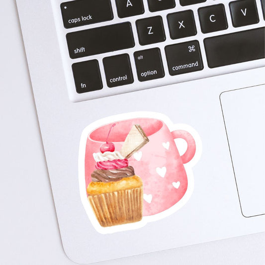 Sticker of a cupcake with a pink mug on a laptop keyboard. Cherry Cupcake Sticker