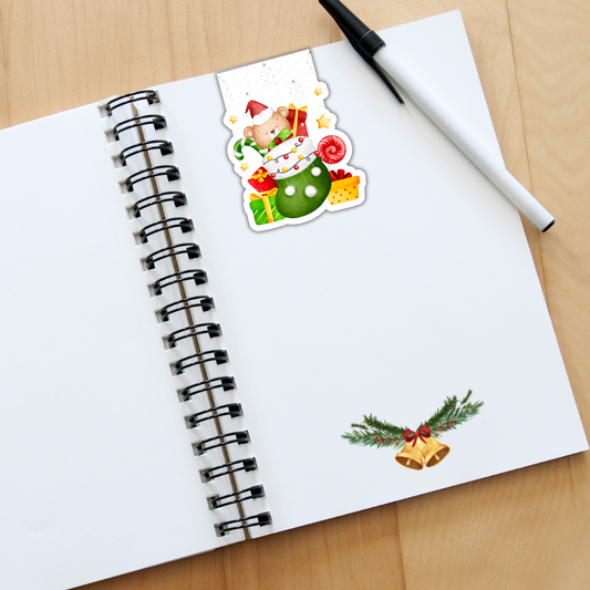 Open notebook with Christmas-themed stickers on a wooden surface. Christmas Gift Magnetic Bookmark 