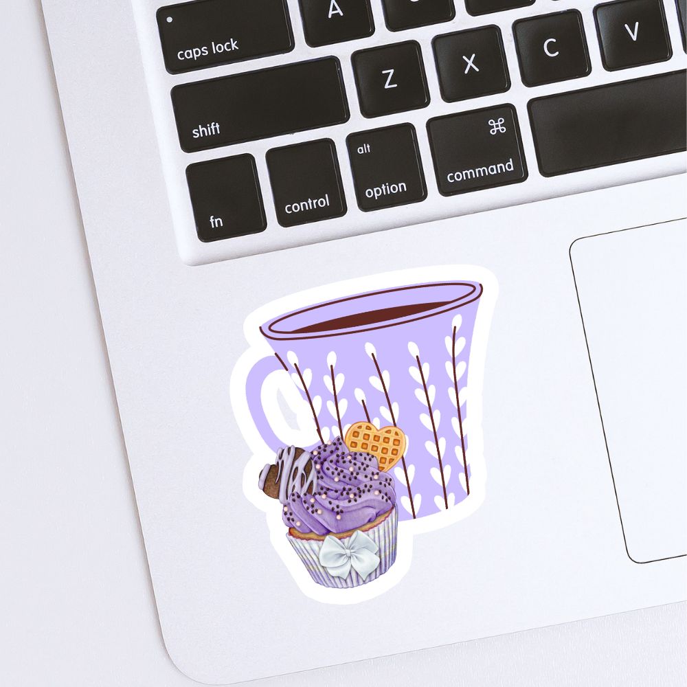 Sticker of a purple mug with a dessert on a laptop keyboard. Coffee and Blueberry Cupcake Sticker