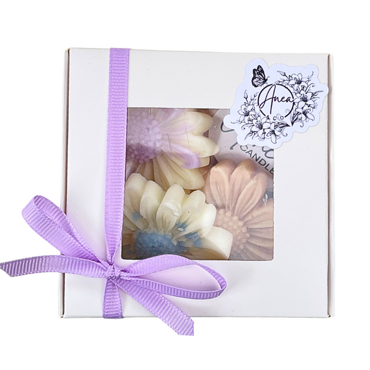 Box of pastel-colored heart-shaped candles with a purple ribbon and 'Areen' label. DAISY WAX MELTS GIFT BOX