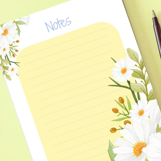 Notebook with floral design on a light green background. DAISY DESIGN A6 NOTEPAD
