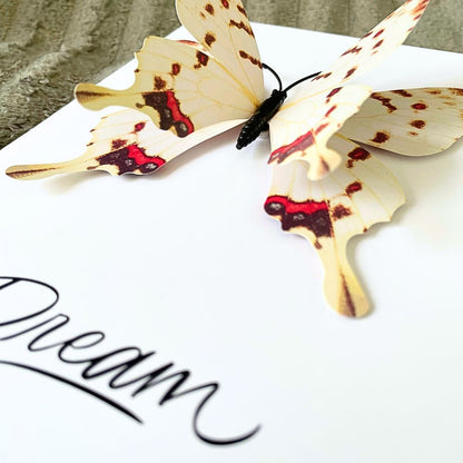 Butterfly-shaped wooden bookmark on a white surface with 'Dream' text. Dream 3D Greeting Card