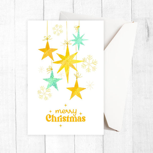 Christmas card with yellow and green stars and snowflakes on a white background. FALLING STARS CHRISTMAS CARD