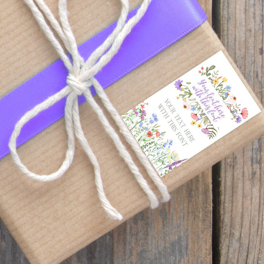 Gift wrapped in brown paper with a purple ribbon and decorative label on a wooden surface. FLORAL PERSONALISED GIFT TAG