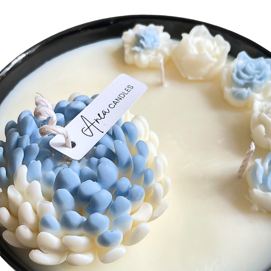 Decorative candle with floral designs and 'Aria Candles' label on a white background, FLOWER NATURAL SOY CANDLE