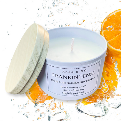 Candle with a wooden lid on a white background, surrounded by orange slices.FRANKINCENSE NATURAL SOY CANDLE