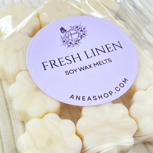 Pack of 'Fresh Linen' soy wax melts with a purple label on a beige background. FRESH LINEN CREAM WAX MELTS 
