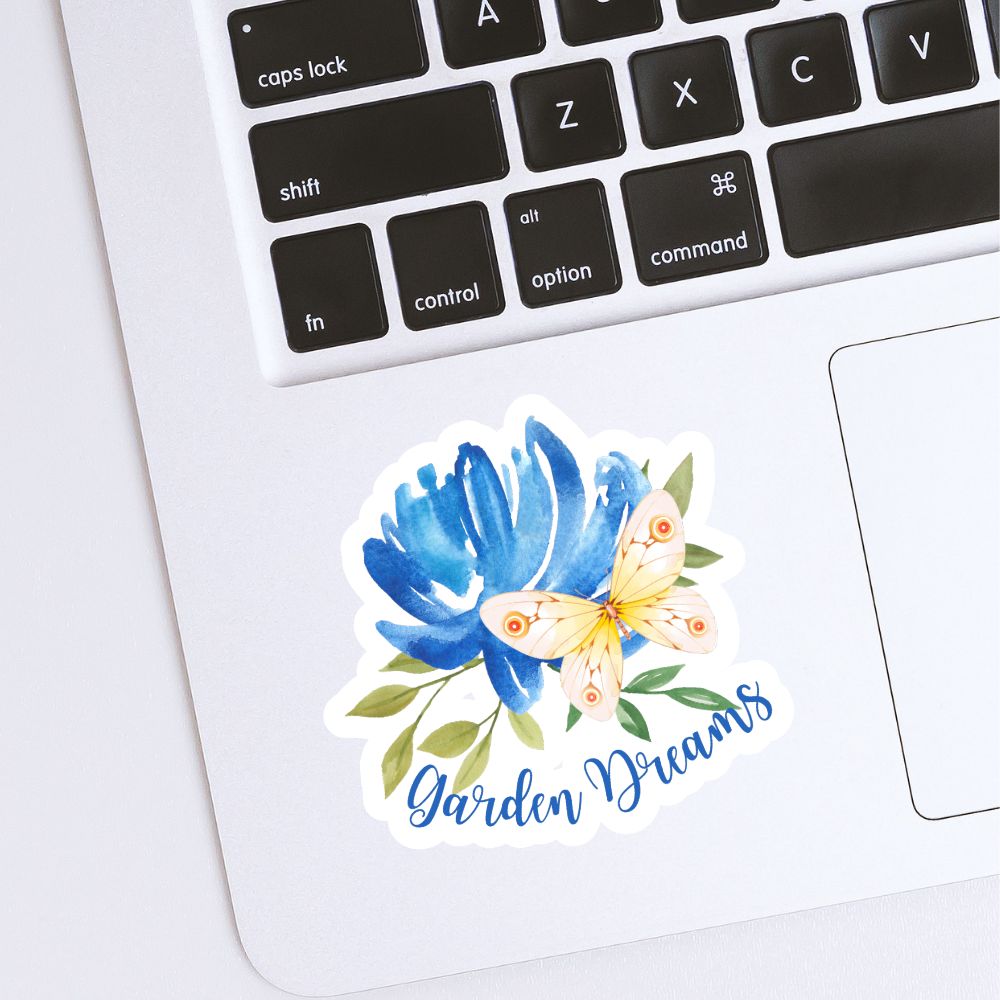 Sticker with blue flower and butterfly design on a laptop keyboard. Garden Dreams Butterfly Sticker