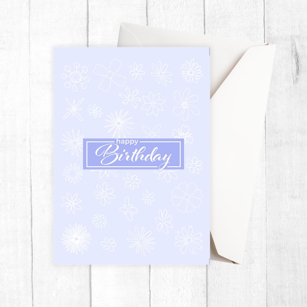 Light blue birthday card with snowflake patterns on a white wooden surface. Gentle Pastels Birthday Card