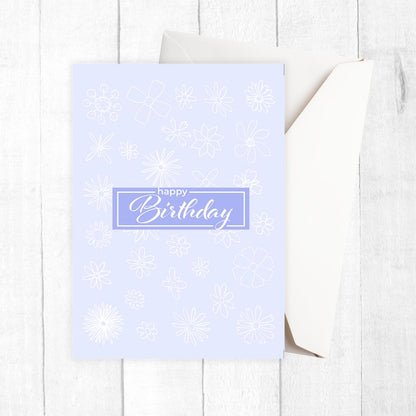 Light blue birthday card with snowflake patterns on a white wooden surface. Gentle Pastels Birthday Card