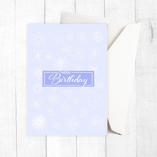 Light blue birthday card with snowflake patterns on a white wooden surface. Gentle Pastels Birthday Card