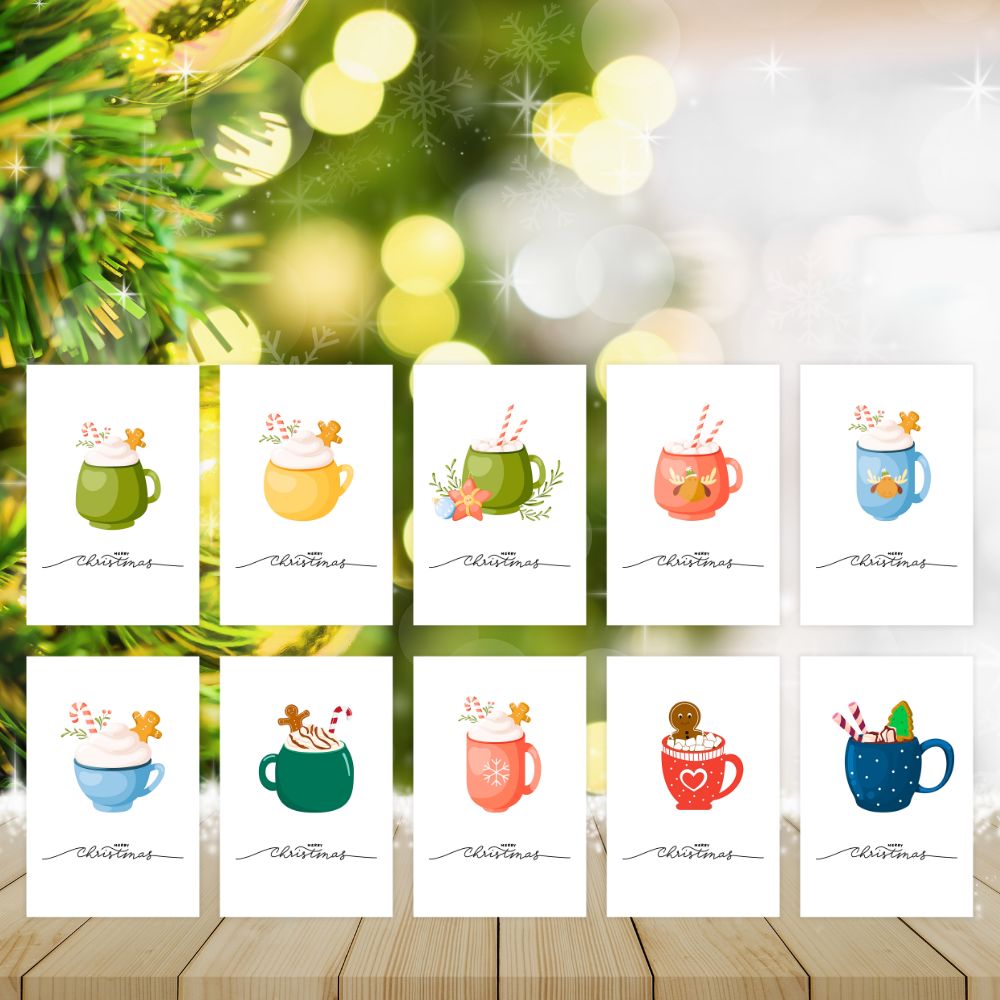 Set of Christmas cards with colorful mugs on a wooden surface with blurred greenery in the background.HOT COCOA CHRISTMAS CARDS