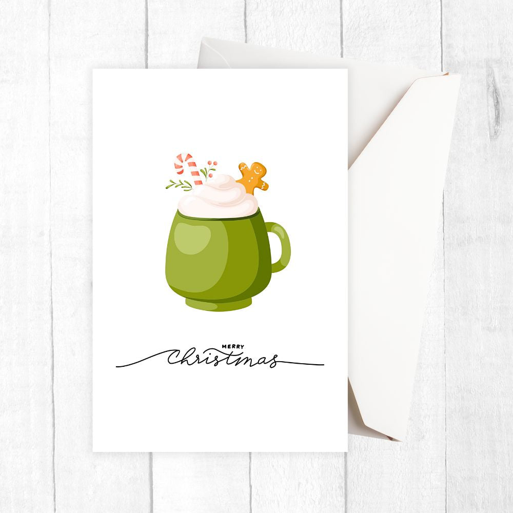 Green mug with whipped cream and a gingerbread man on a white background. HOT COCOA CHRISTMAS CARDS