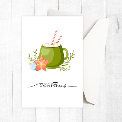 Christmas-themed card with a green mug, flowers, and 'Merry Christmas' text on a white background. HOT COCOA CHRISTMAS CARDS