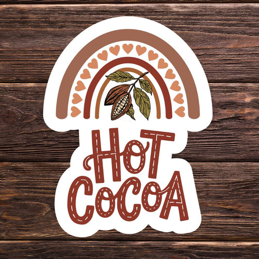 Sticker with 'Hot Cocoa' text and cacao bean design on a wooden background. HOT COCOA STICKER