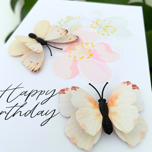Greeting card with butterfly decorations and 'Happy Birthday' text on a white background