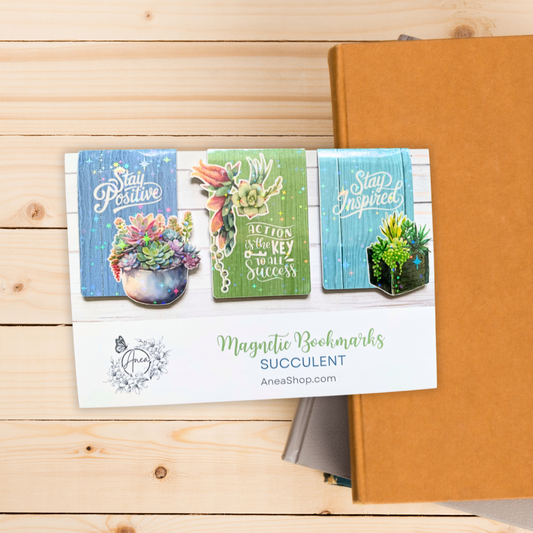 Magnetic bookmarks with succulent designs on a wooden surface. Inspirational Magnetic Bookmark Set