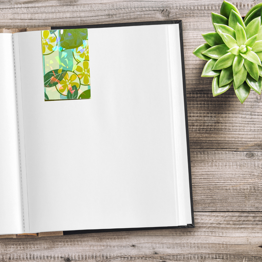 Open notebook with a floral bookmark on a wooden surface next to a green succulent plant. Juicy Fruit Bookmark Set