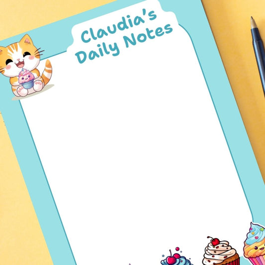 Notepad with 'Claudia's Daily Notes' text and a cartoon cat on a yellow background. KAWAII CUPCAKES PERSONALISED A6 NOTEPAD