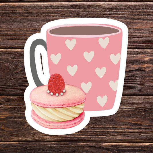 Pink mug with heart pattern and pink macaron on a wooden background. Love Coffee Cupcake Sticker.