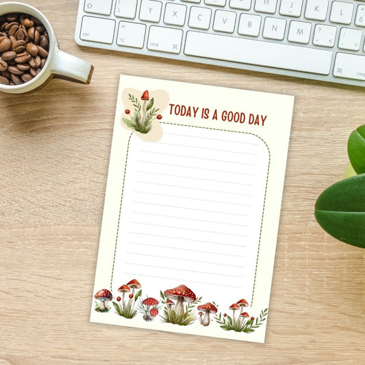 Notebook with 'Today is a Good Day' text on a desk with coffee and keyboard. MUSHROOM PERSONALISED A6 NOTEPAD
