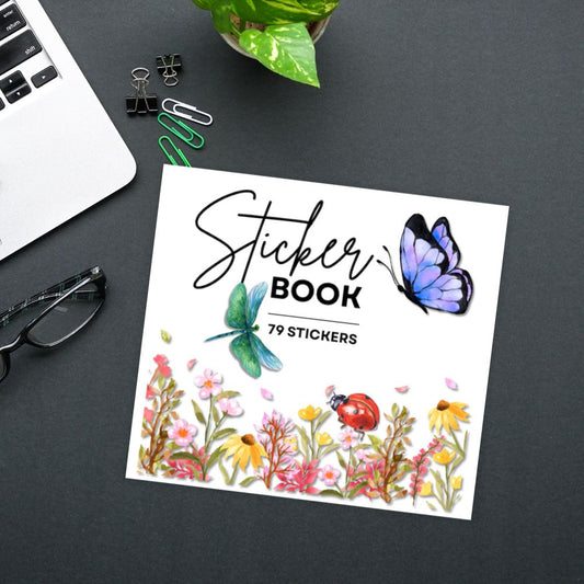 Sticker book with butterfly design on a desk with laptop and stationery items. NATURE STICKER BOOK