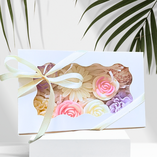 Gift box with floral design and ribbon on a white background with green leaves.PASTEL FLOWERS GARDEN WAX MELTS GIFT BOX