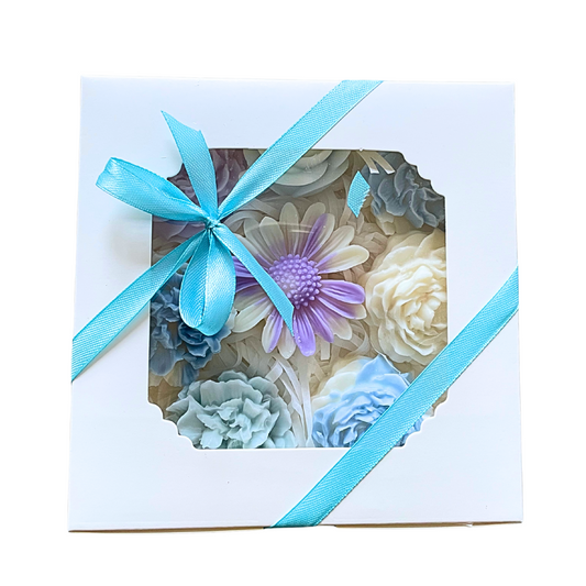 Decorative flowers in a box with a blue ribbon on a white background. PASTEL FLOWERS WAX MELTS GIFT BOX