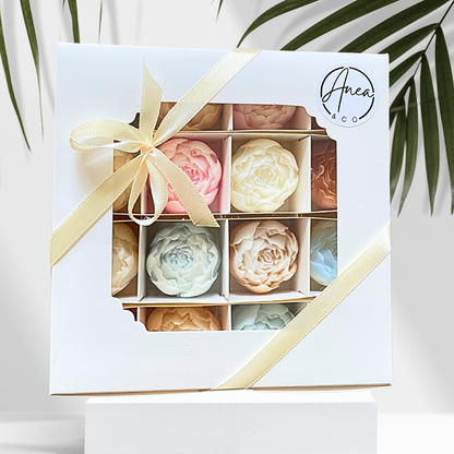 Box of pastel-colored soap bars with a decorative ribbon, featuring the brand 'Anea & Co'. PEONIES WAX MELTS GIFT BOX