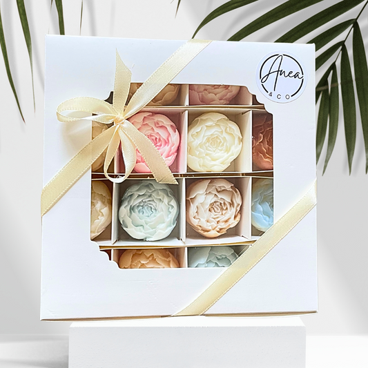 Box of pastel-colored soap bars with a decorative ribbon, featuring the brand 'Anea & Co'. PEONIES WAX MELTS GIFT BOX